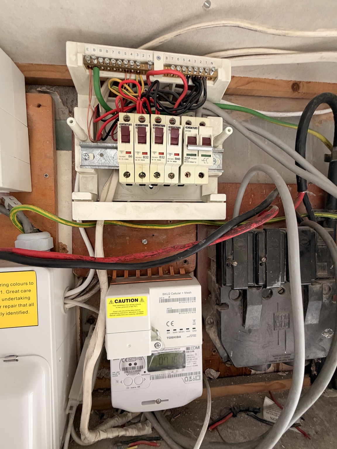Original consumer unit with its cover removed during the Kilburn replacement work