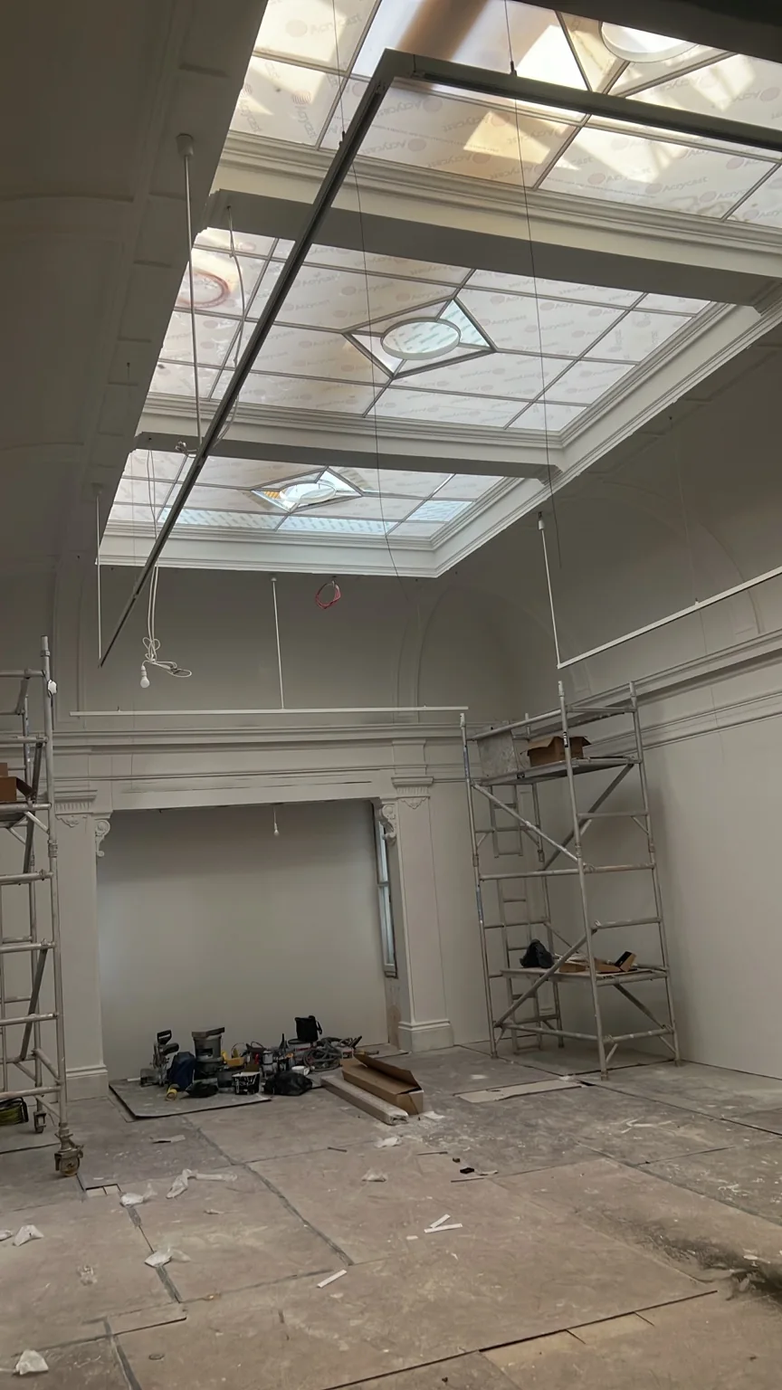 Suspended lighting tracks and scaffold during the gallery installation